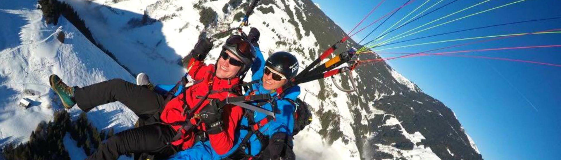 A man enjoying the breathtaking view of the beautiful countryside from above together with his experienced paragliding pilot from Fly with Tom.