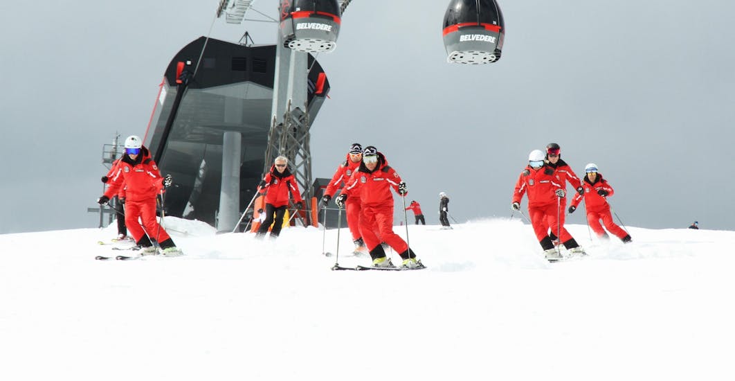Some instructors from Ski School Top Ski Piculin San Vigilio are descending from a slope in San Vigilio di Marebbe.