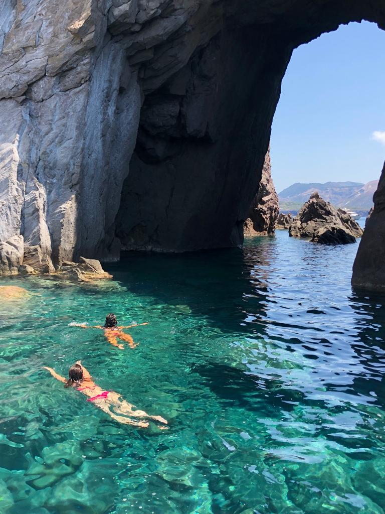 Some people are having fun while swimming in the sea. 