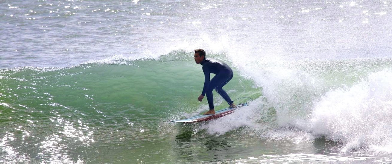 A man surfing near Lisbon with GetWet Surf School and Tours.