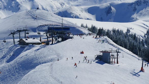 Adults and kids skiing in Grossarl ski resort.