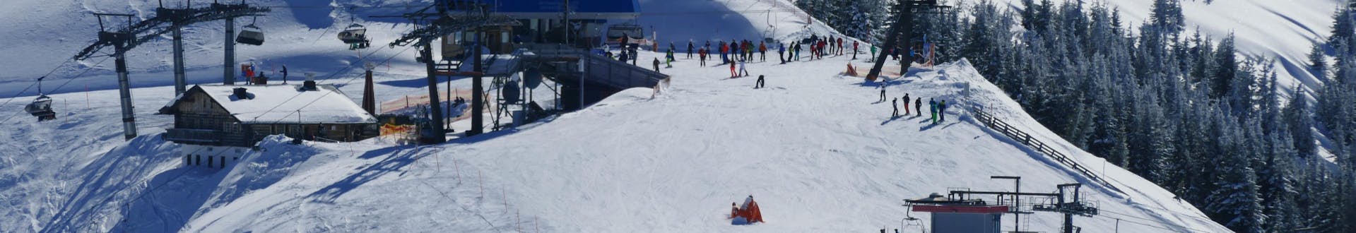 Adults and kids skiing in Grossarl ski resort.