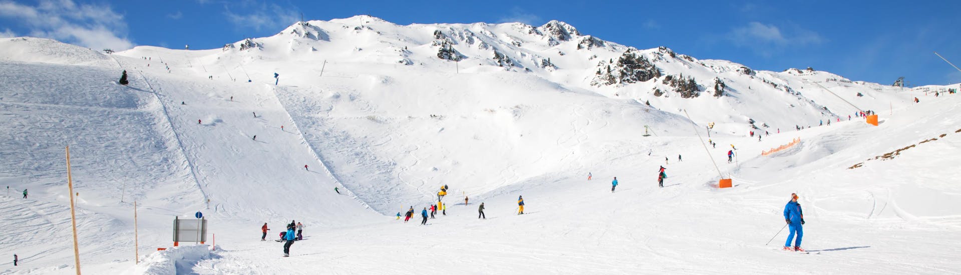 Adults and kids skiing in Hochfugen ski resort.