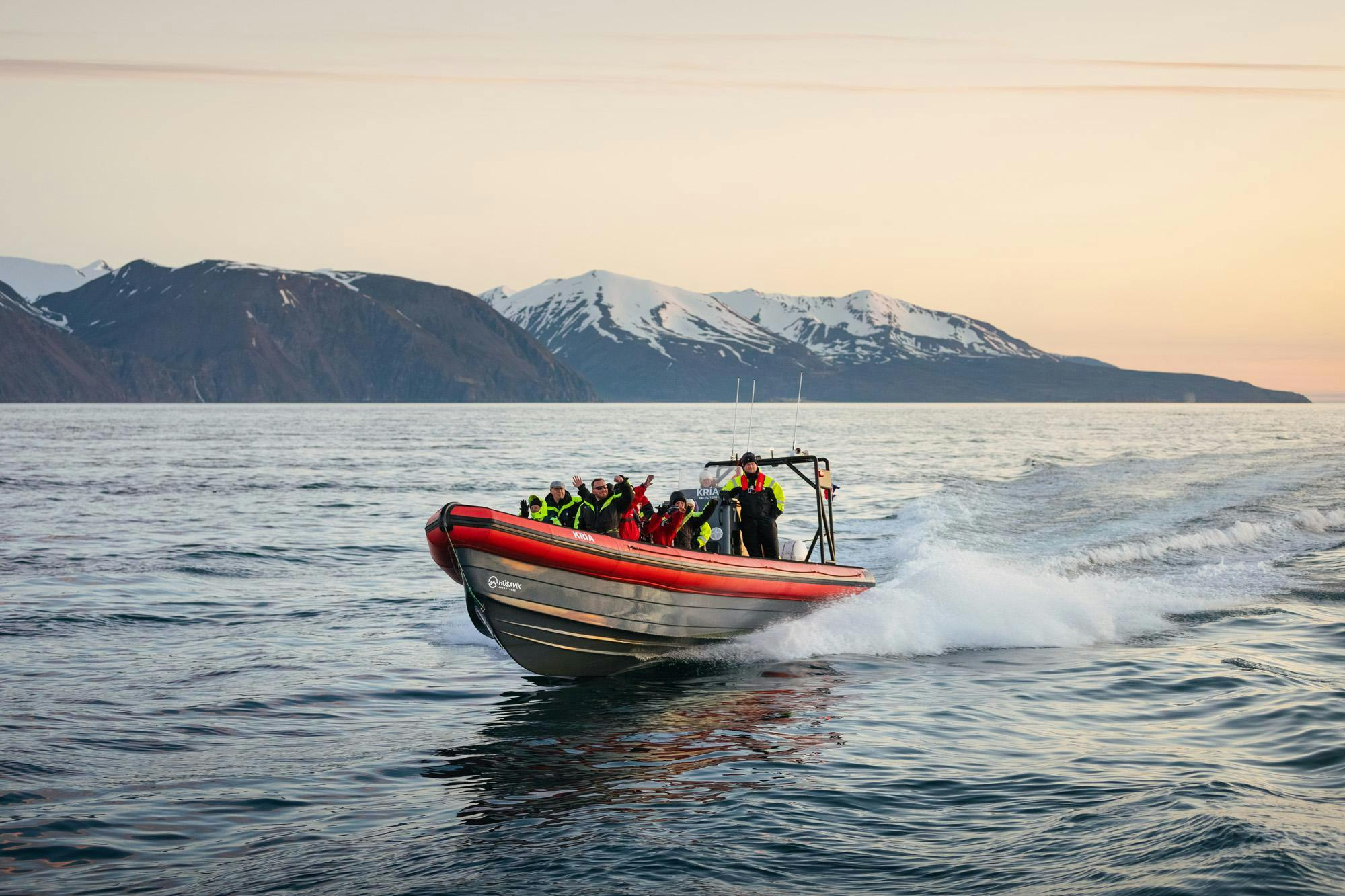 Húsavík Adventures RIB boat riding along the shore of Húsavík during the boat trip with Húsavík Adventures.
