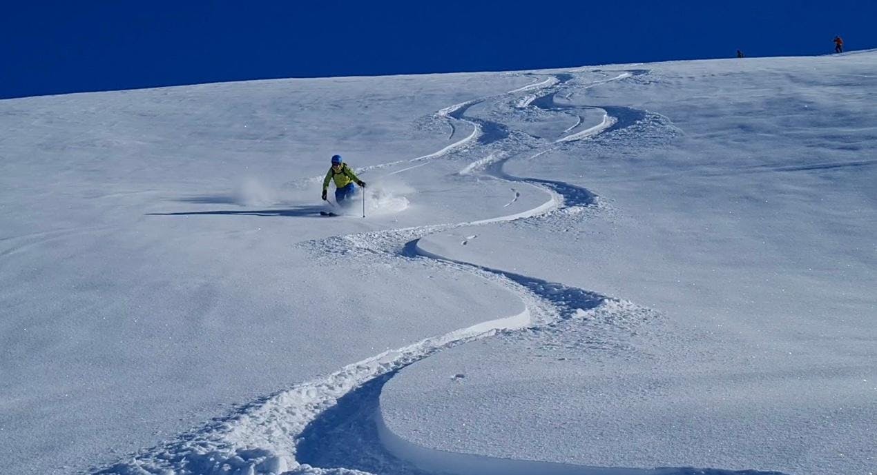 Skiguide Ischgl A ski instructor from Skiguide Ischgl skiing down a powdery slope.