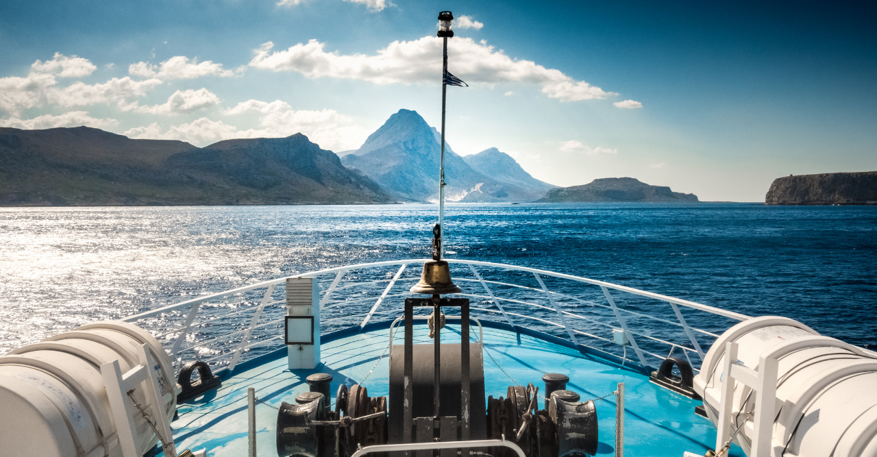Front of boat with mountains in the back during an activity from Island Spy Crete. 