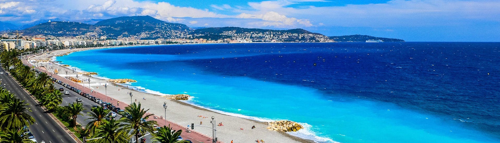 An image of the beautiful beach promenade and the deep blue waters of the Côte d'Azur you get to see when riding a jet ski or doing other water sports activities in Nice.