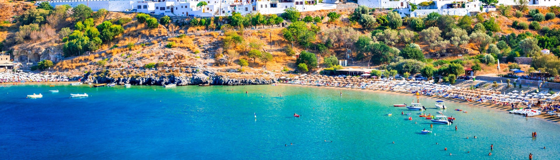 An image of one of the beautiful beaches where you can try jet ski or other water sports in Rhodes.