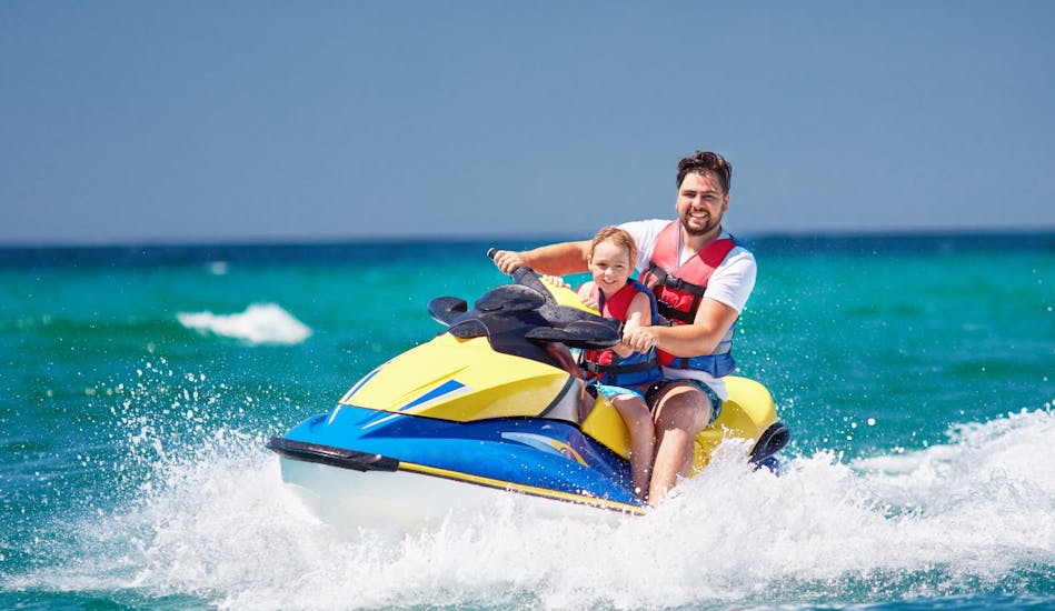 Father and daughter are having fun on a jetski