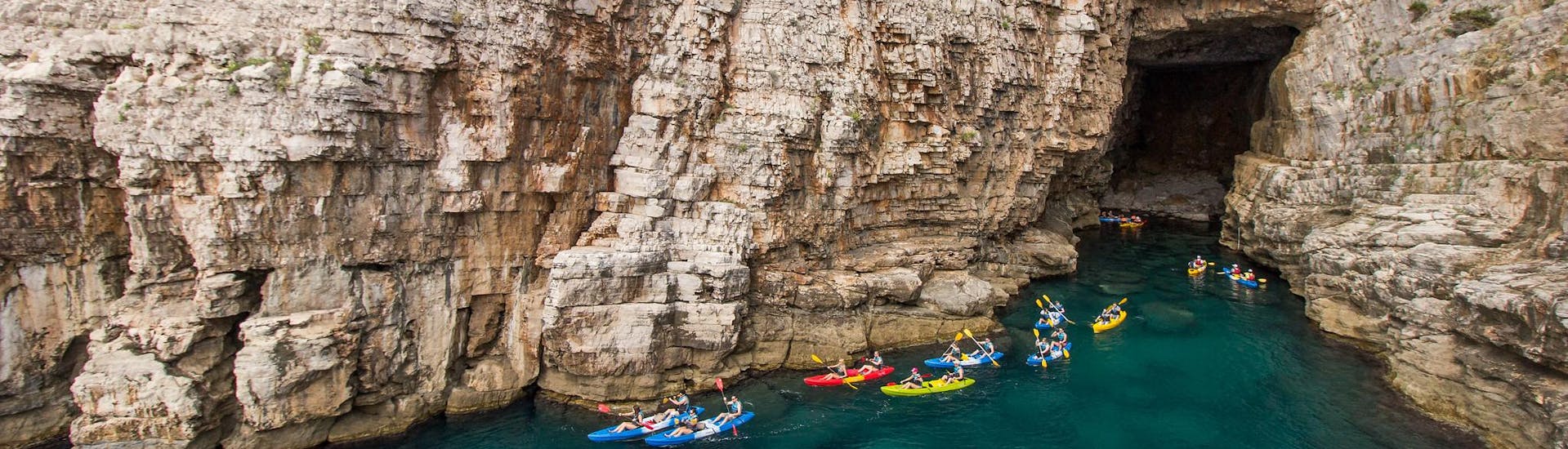 People having a great time during a kayak tour to caves.