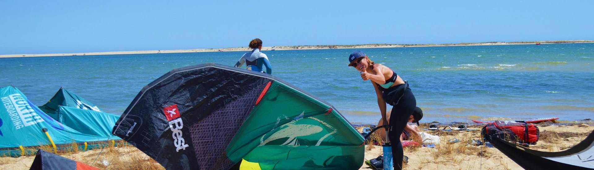 A participants of the kitesurfing lessons with Kite Culture Algarve is getting ready for her session on the Fuseta Lagoon.