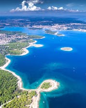 A panoramic view of a city on the cliffside in Croatia where you can do windsurfing and kitesurfing in Pula.