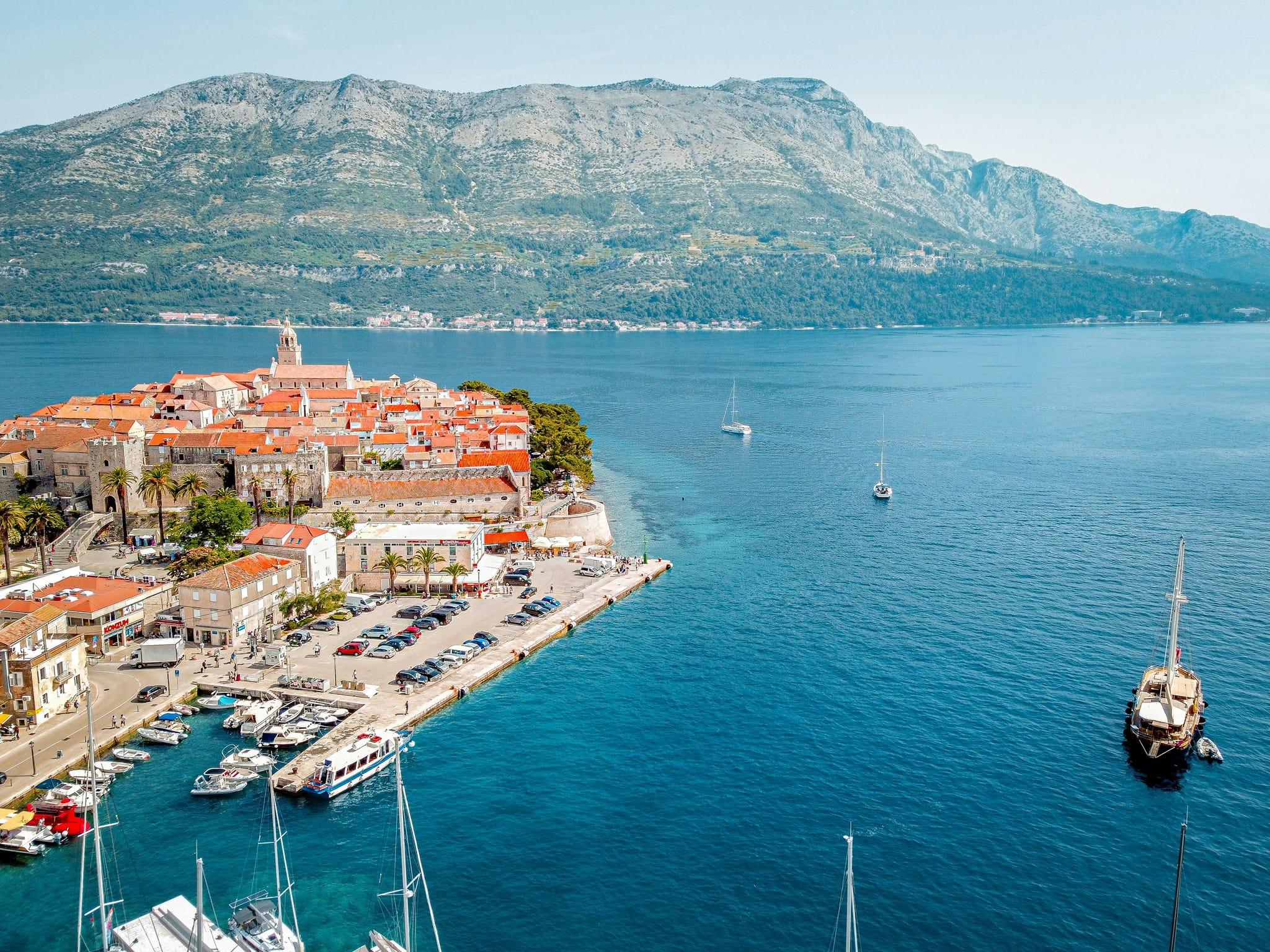 Horizontal image of Korčula town, where Korkyra Info Korčula is located and the archipelago is shown in the background.