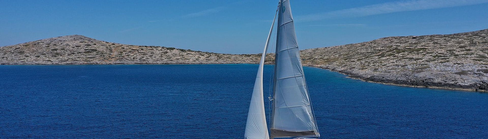 A catamaran on the beautiful and crystal clear Greece sea on a cruise from DanEri Yachts Crete