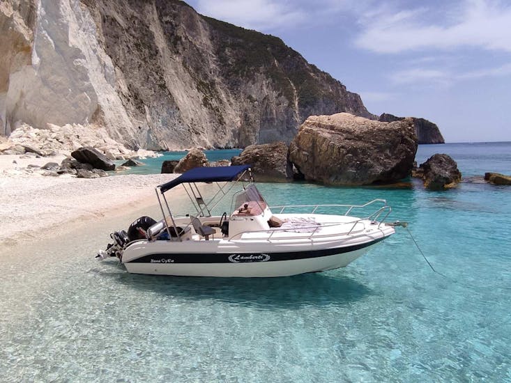 A boat on the crystal clear water and white sand. 
