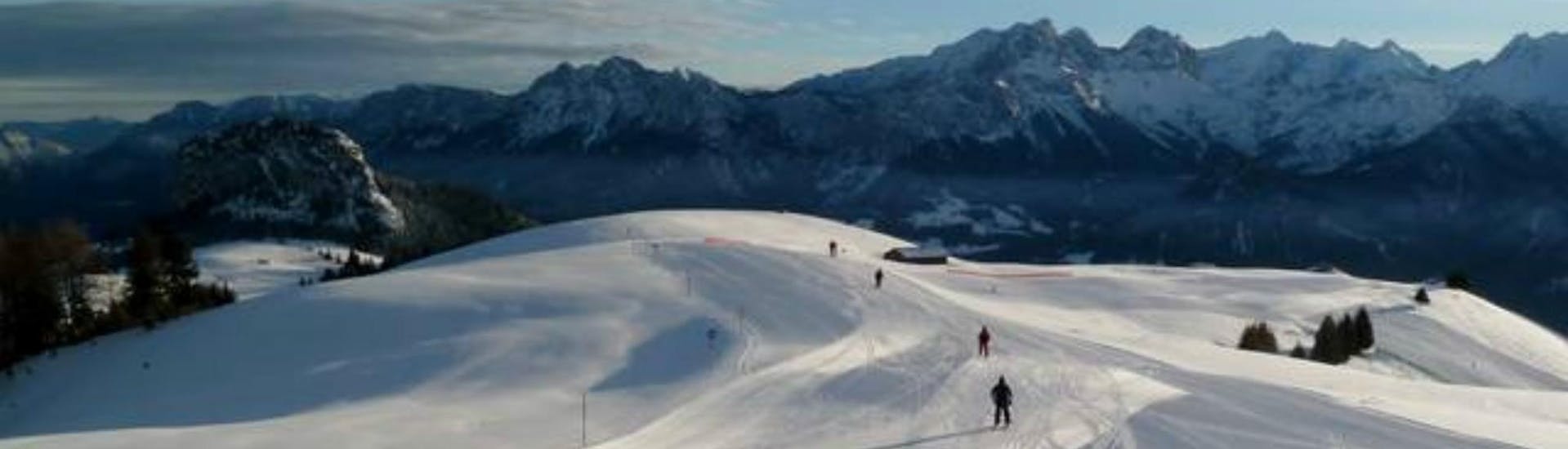 A view of a snowy mountain top in the ski resort of Loser-Altaussee, where ski schools gather to start their ski lessons.