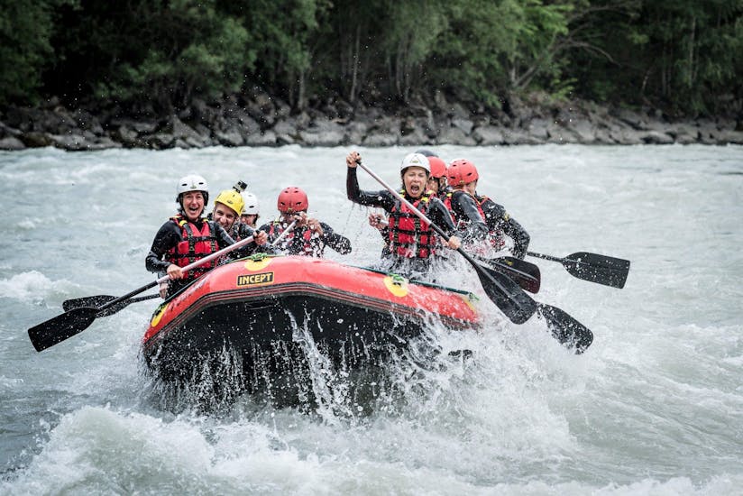 The participants of a rafting tour organized by Natur Pur Outdoorsports are facing splashing rapids in the Ötztal valley.