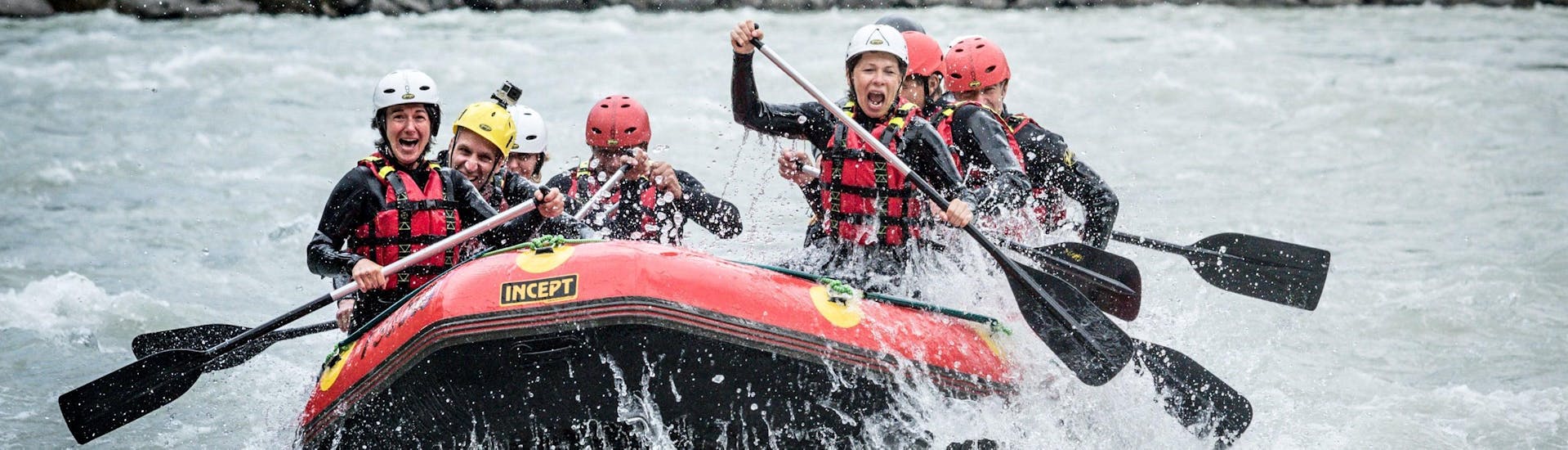 The participants of a rafting tour organized by Natur Pur Outdoorsports are facing splashing rapids in the Ötztal valley.