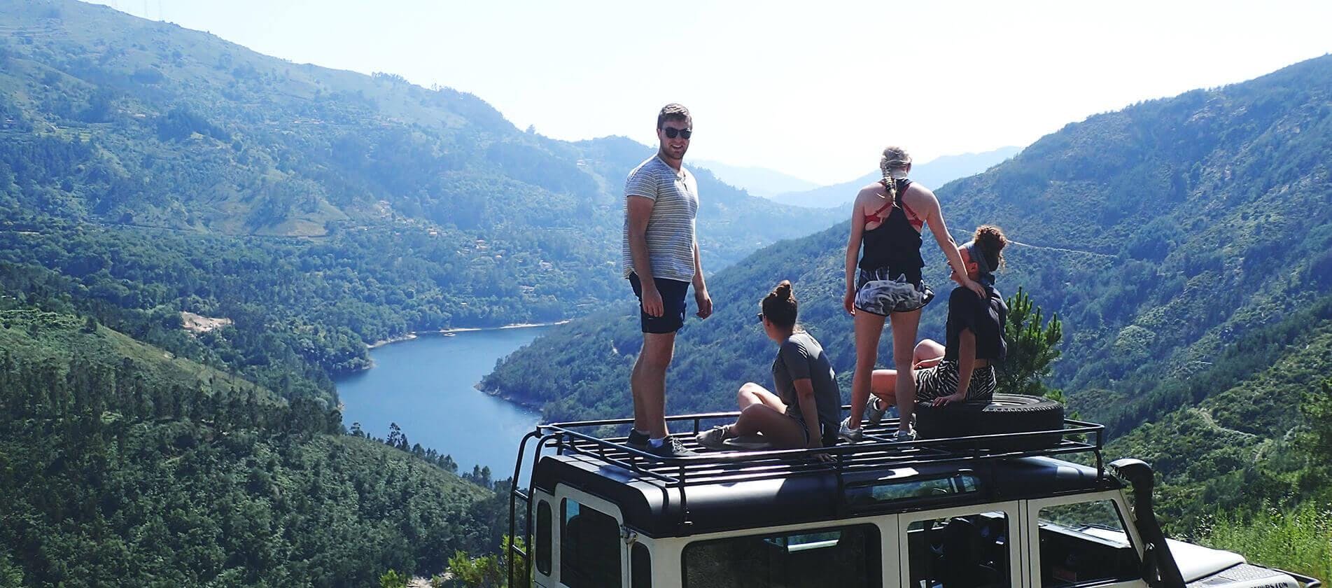 oporto-adventure-tours-hero A group of young people is enjoying the view of the spectacular landscape around them from the top of a jeep provided by Oporto Adventure Tours.