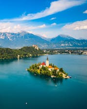 An aerial view of the famous lake with its small church on an island, a sight awarded to those who go paragliding in Bled.