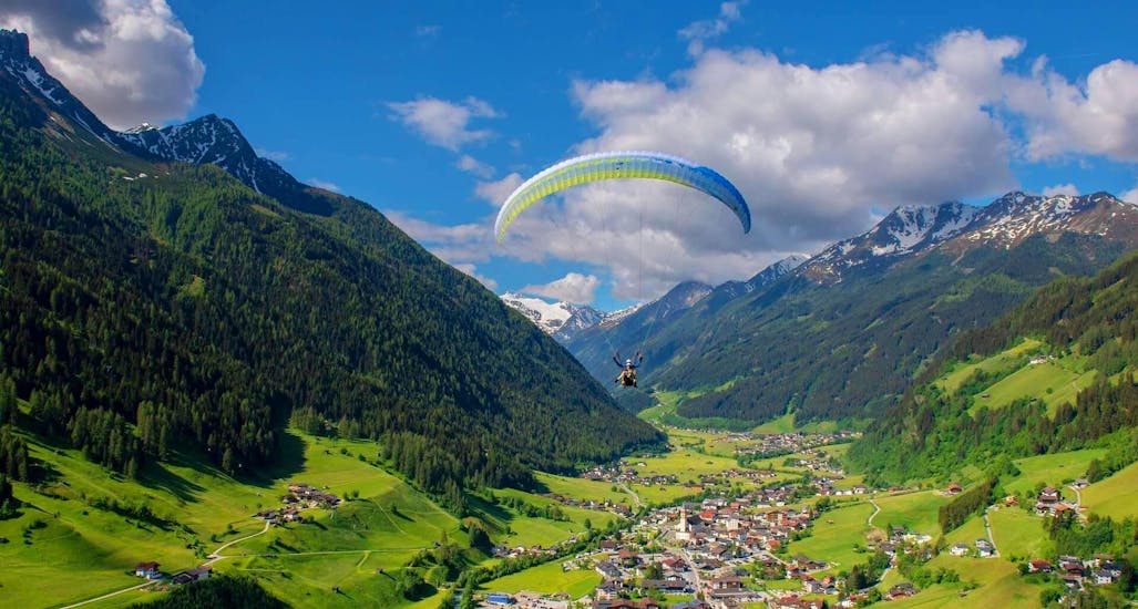 Two people enjoying a tandem flight near Innsbruck with Paragliding Tirol.