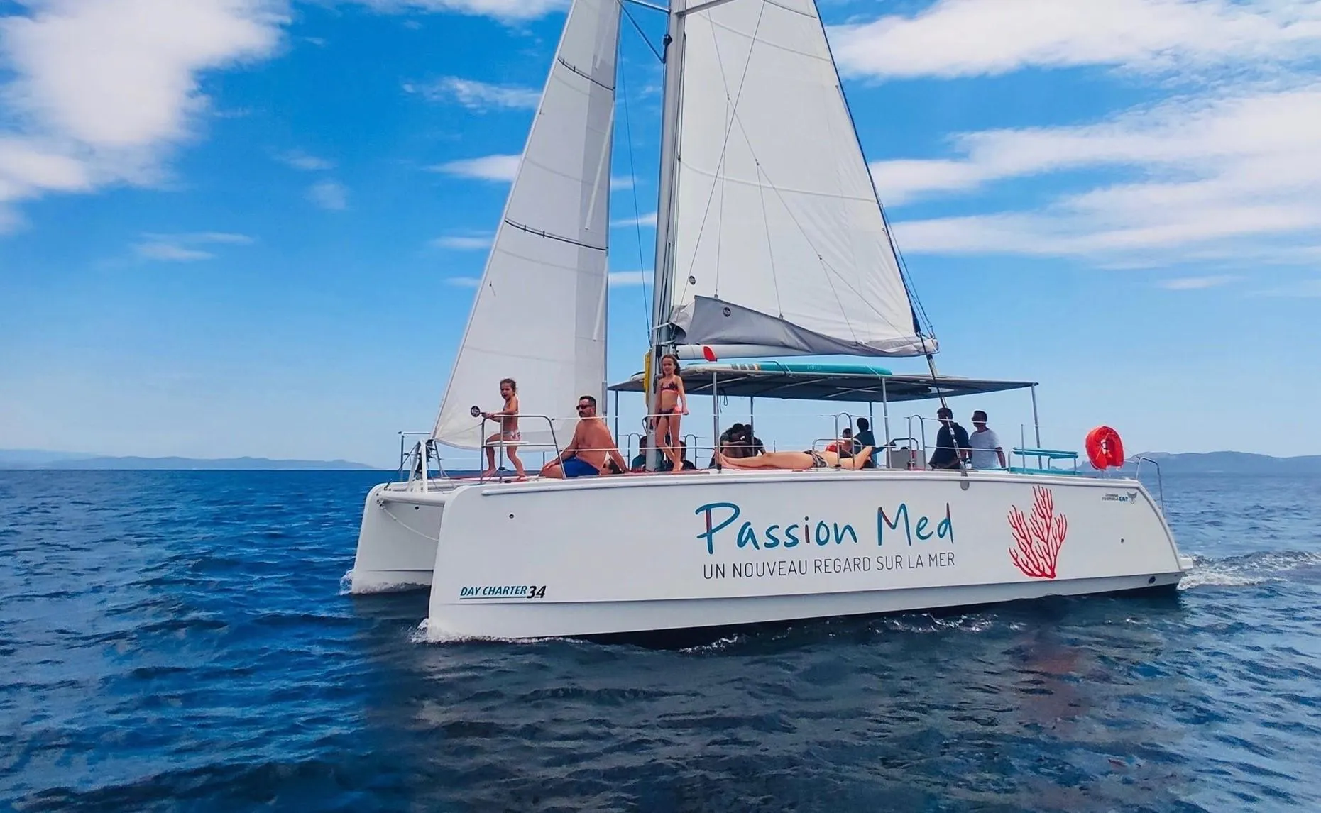 Beautiful landscapes showcasing mountains and sea, where the experiences of Passion Med - Catamaran Var are taking place.