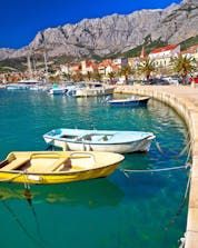 A summer landscape photo of a city-port in Croatia where you can do rafting in Makarska.