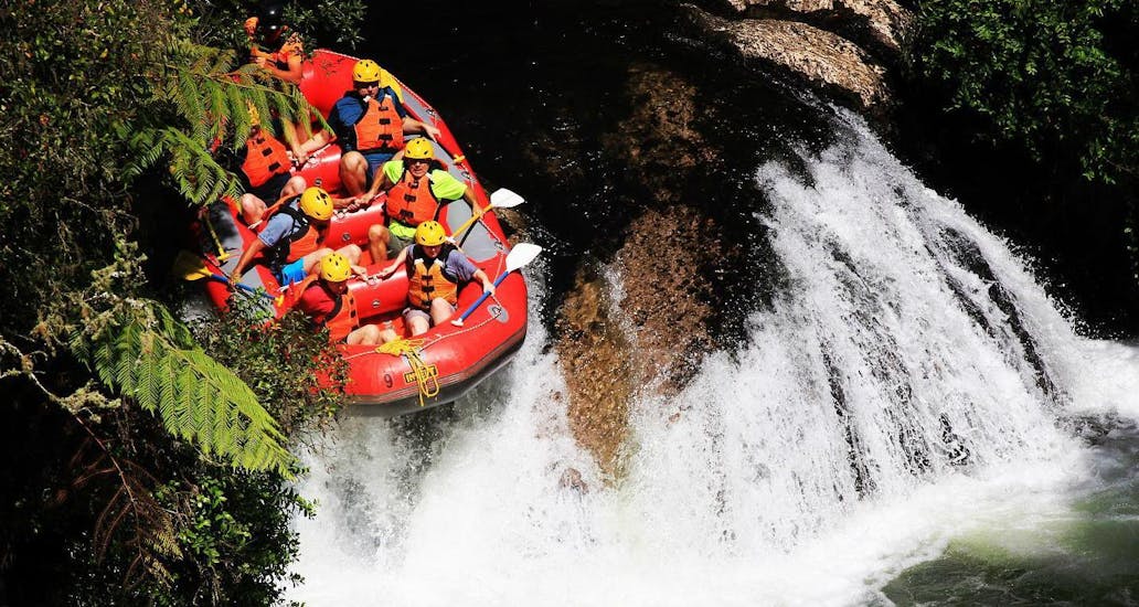 A group of rafters is taking the plunge at the famous Tutea Falls, worlds highest commercially rafted waterfall, during a tour with Rafting Adventure Rotorua.