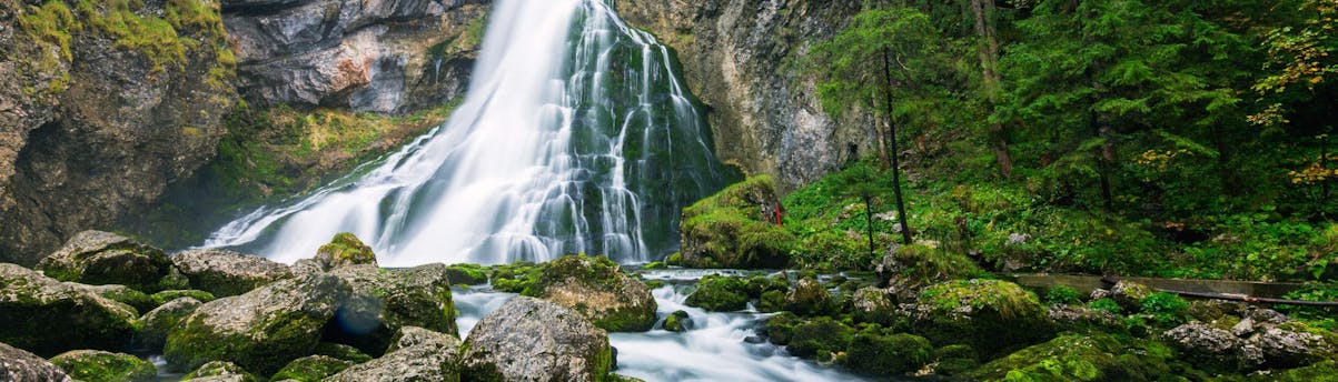 rafting-canyoning-golling_SEM-Resort-Hero Ein Bild des Gollinger Wasserfalls nahe der Salzach, auf der beim Rafting in Golling gepaddelt wird.