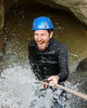 A young man is seemigly having lots of fun canyoning in Greifenburg.