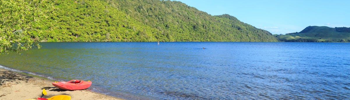 rafting-canyoning-lake-okareka_SEM-Resort-Hero An image of two kayaks on the shores of Lake Okareka in the Rotorua region, a popular hotspot for kayaking in New Zealand.