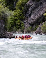 A group of people go rafting in the river in Murillo de Gállego with a rafting provider during summer.