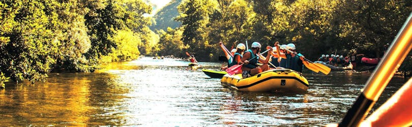 Several groups of people are paddling along the Cetina River while rafting near Omiš.
