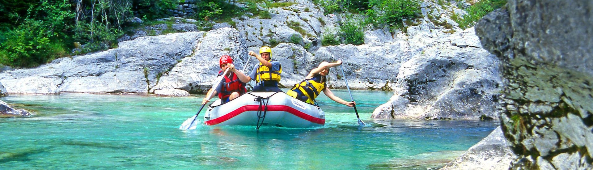 A group of young people enjoying some white water rafting fun in the rafting & canyoning hotspot of Učja Valley.