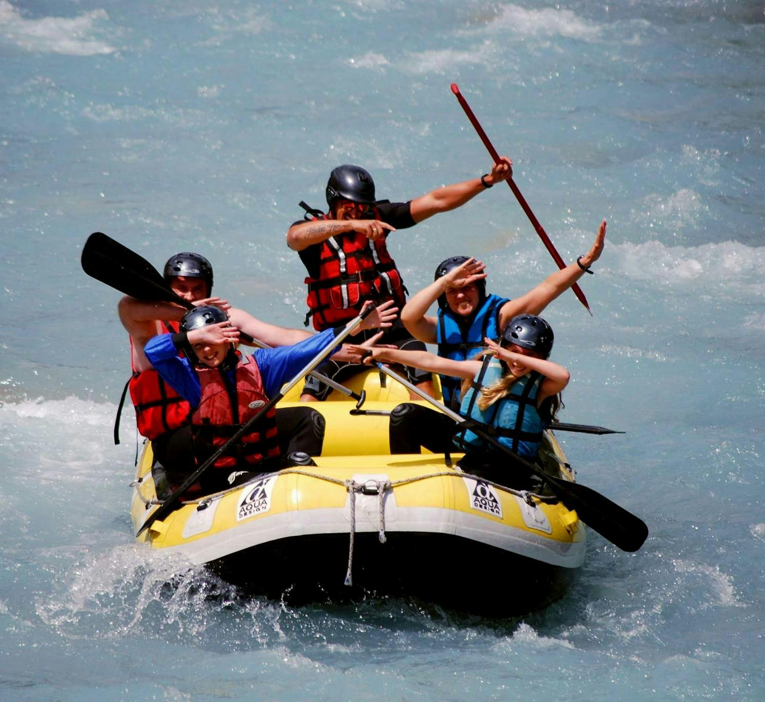 A group on a raft is having fun during their discover session on the Guisane river with Piraft rafting in Serre-Chevalier. 