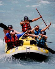 A group on a raft is having fun during their discover session on the Guisane river with Piraft rafting in Serre-Chevalier. 