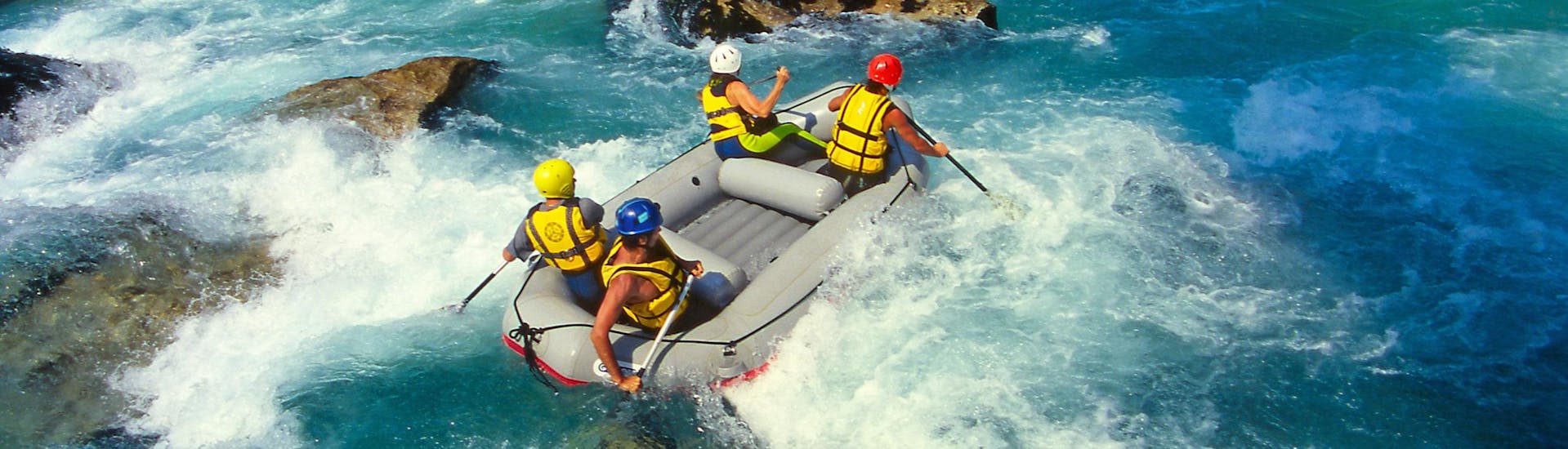 A group of friends having fun on a white water rafting tour in the rafting hotspot of Erpfendorf.