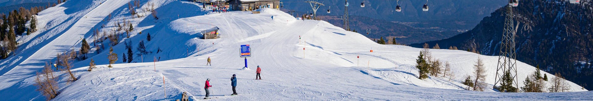 Adults and kids skiing in Rauris ski resort.