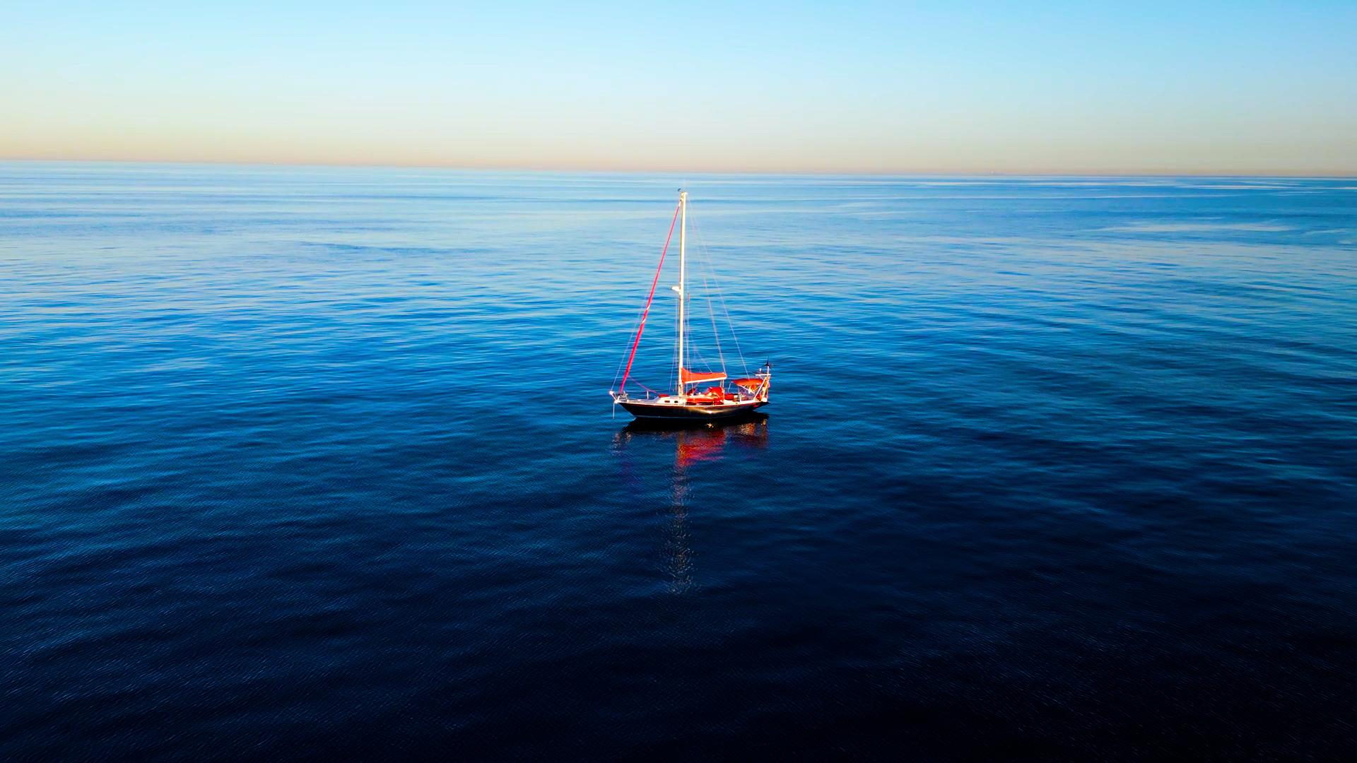 A sailboat in the middle of the sea