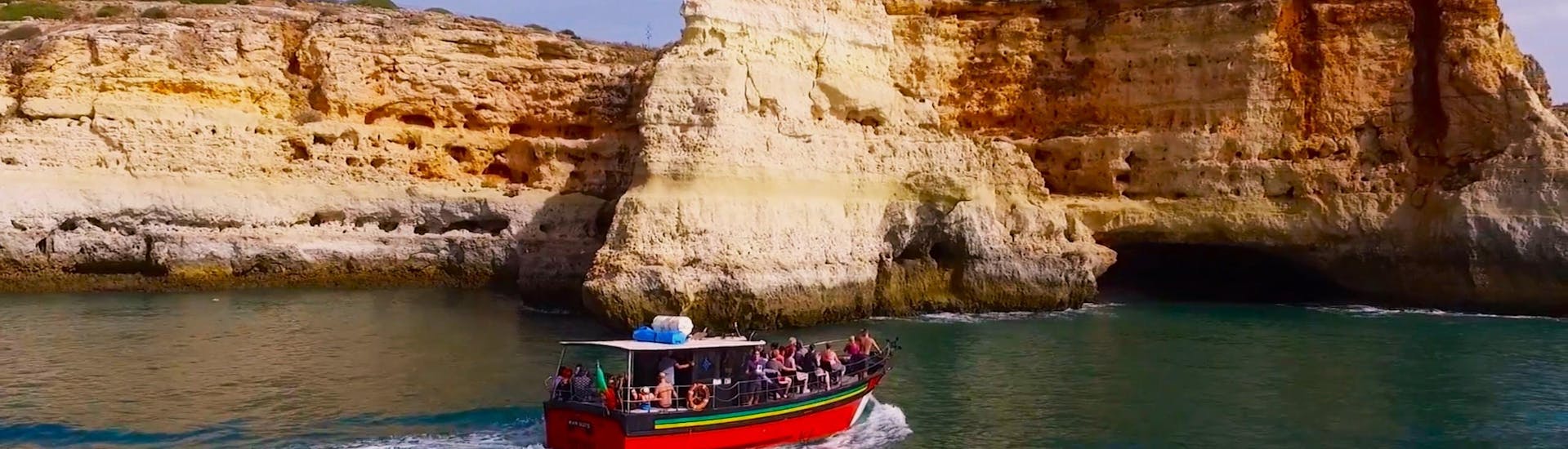 Participants on a motorboat enjoying a boat trip from Portimao to the Benagil Cave with Manguitu's.