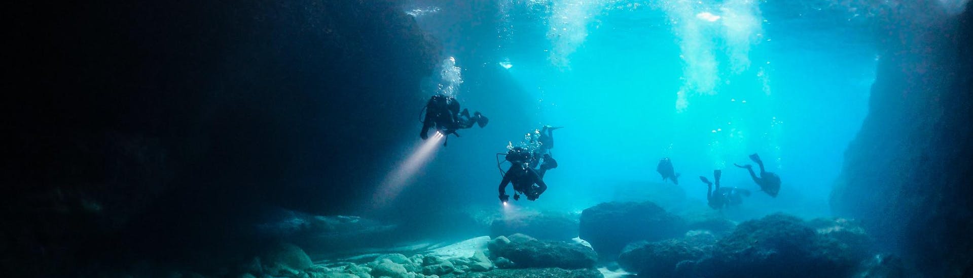 A group of certified divers during an activity in an underwater cave.