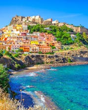 An image of Castelsardo town, surrounded by the clear blue waters of the Mediterranean that are so popular with people who go scuba diving in Sardinia.