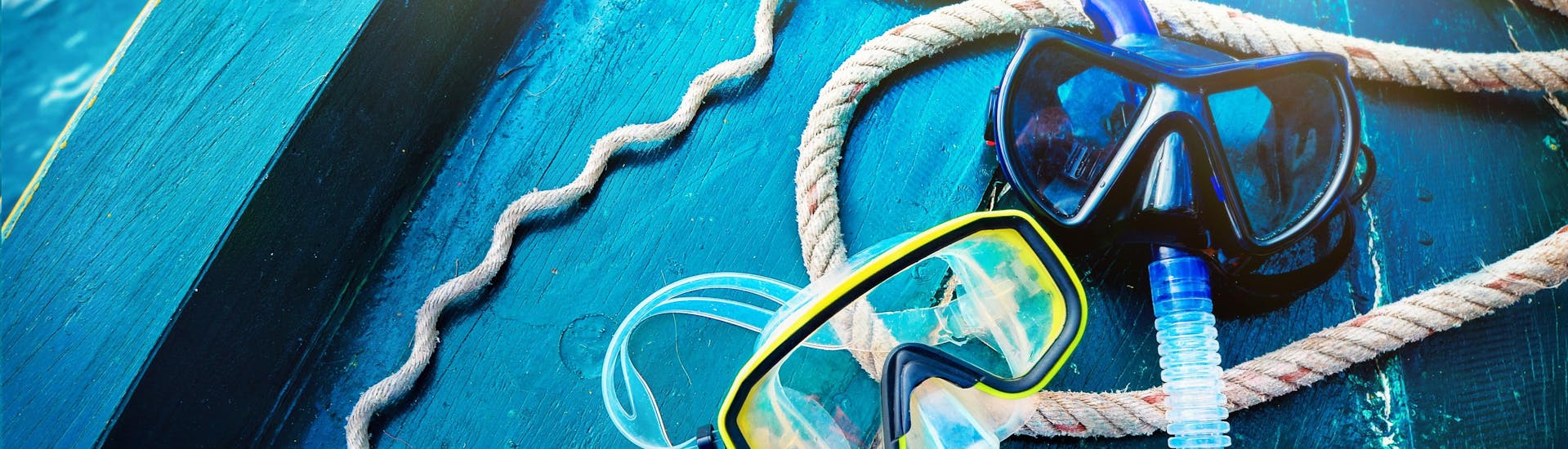 Two sets of goggles and a snorkel lie prepared on a boat, ready to be taken snorkeling in Mallorca.