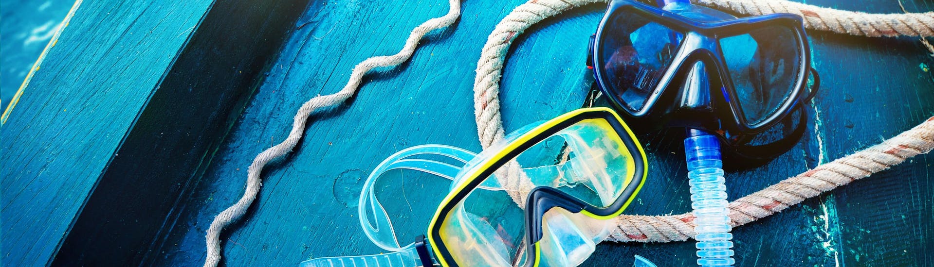 Two sets of goggles and a snorkel lie prepared on a boat, ready to be taken scuba diving in Mallorca.