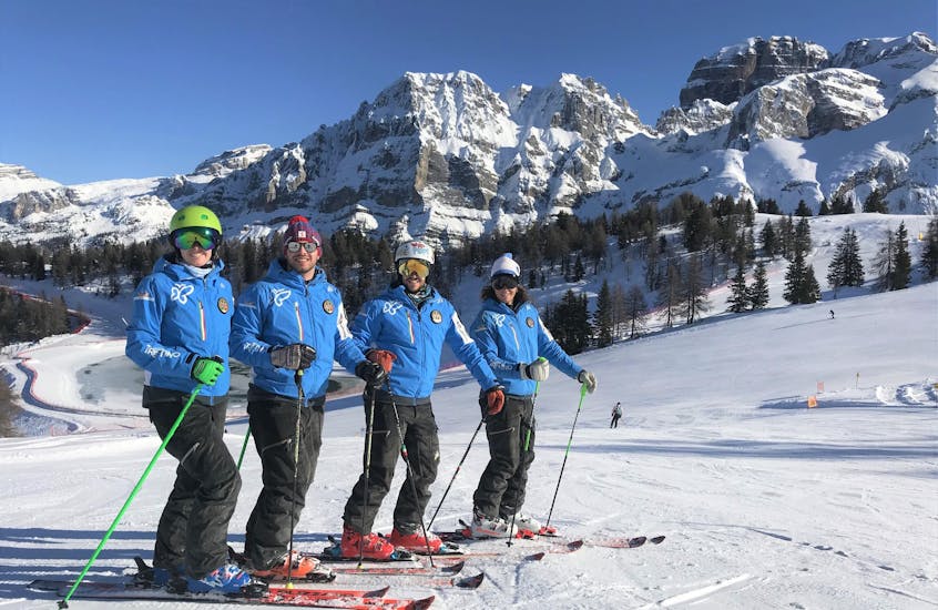 Some instructors of the ski school Scuola di Sci Pinzolo are smiling at the camera before heading to the slopes and give private and group lessons in the Val Rendena ski resort.