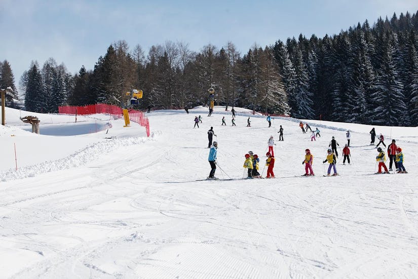 Un gruppo di bambini scia in pista durante una lezione di sci a Folgaria con la Scuola Italiana Sci Folgaria - Fondo Grande.