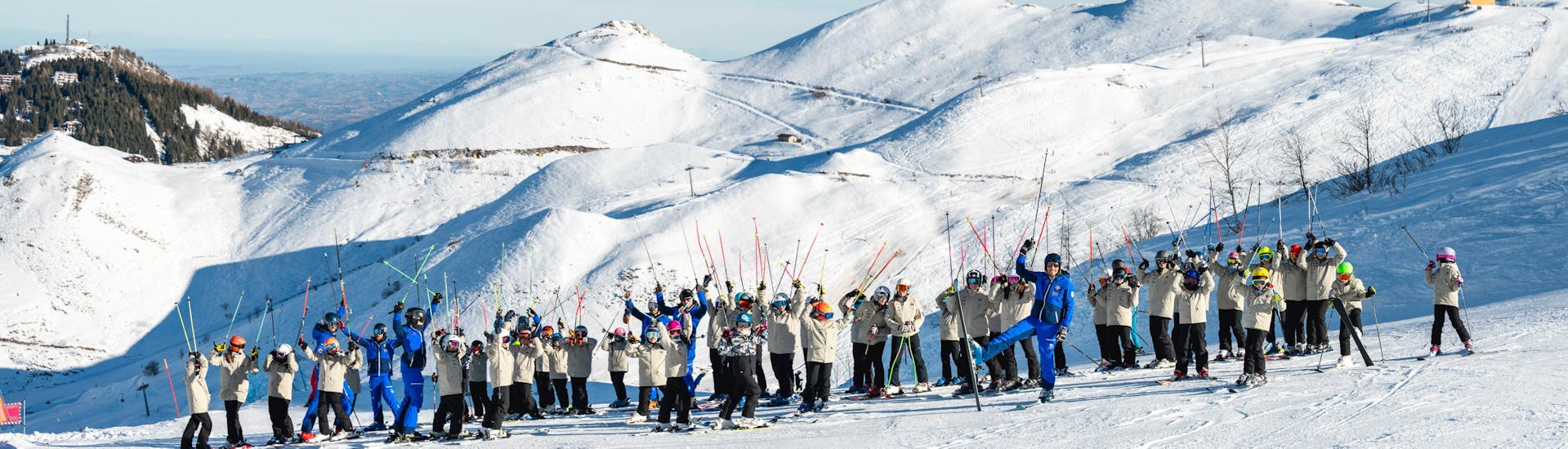 Scuola di Sci e Snowboard Prato Nevoso The ski and snowboard instructors of Scuola di Sci e Snowboard Prato Nevoso with a snowy mountain backdrop.