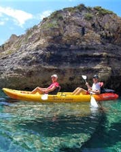 A couple goes sea kayaking around Cape Kamenjak in Premantura together with Pula Outdoor. 