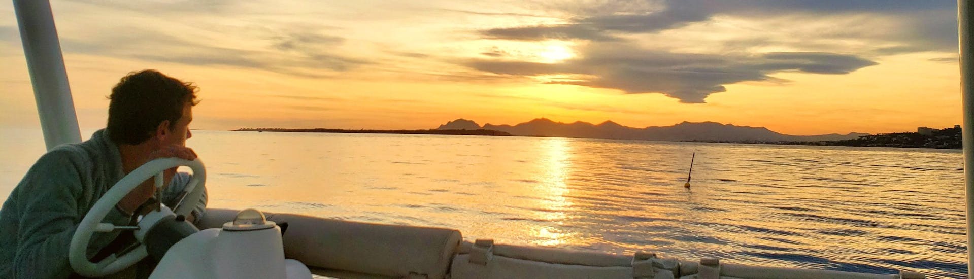 A man is enjoying a private catamaran trip at sunset off Juan-les-Pins with SeaZen.
