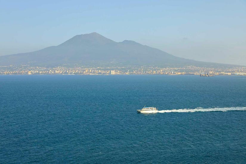 The boat Benedetta II is navigating along the Sorrento Coast.